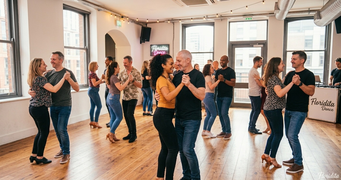 Happy diverse couples dance Bachata intimately in a modern, sunlit studio with large windows - Floridita Dance Manchester - Bachata classes Manchester